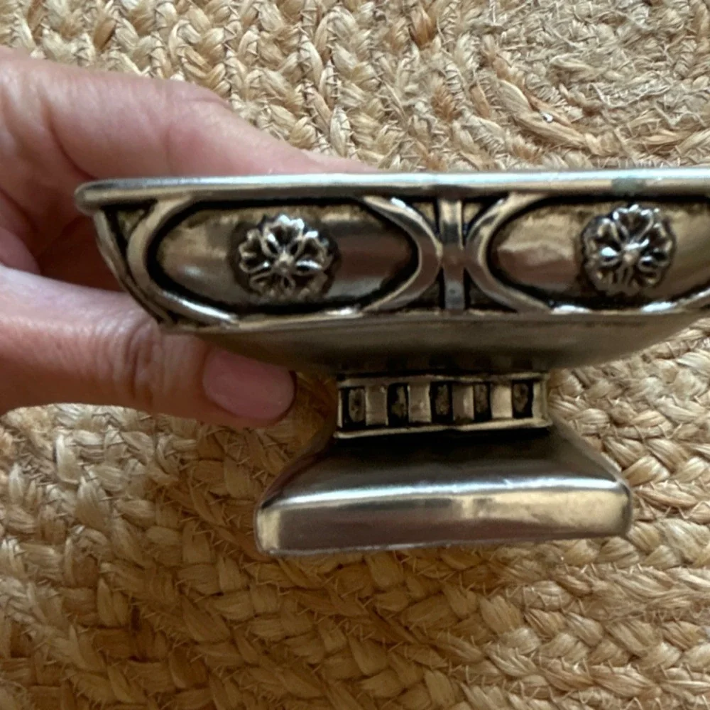 decorative silver-tone pedestal dish, likely used as a soap dish, trinket holder